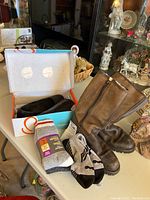Photo showing Baretraps leather shoes in box, three pairs of socks, and brown leather boots with side zipper.