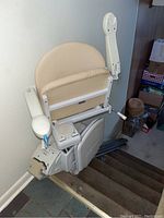 Full view of the stair lift installed on straight stairs showing seat, rail, and drive unit
