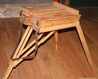 Photo of the French portable easel unfolded with its legs extended and showing the tray for art supplies underneath.