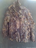 Leafy patterned ghillie style camo jacket with 3D fabric elements for hunting camouflage.
