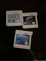 Photo showing three loose Nintendo 3DS game cartridges: Rabbids Rumble, Fast & Furious Showdown, and Steel Diver.
