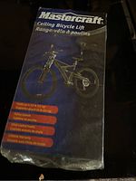 Box of Mastercraft ceiling bicycle lift showing product image and features