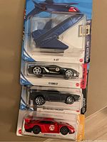 Photo of four new Hot Wheels vehicles in packaging: X-Jet, '17 Ford GT, '70 Ford Thunderbird, red number 70 car