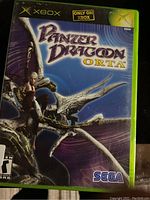 Xbox game case featuring Panzer Dragoon Orta cover art, showing a character on a dragon with purple background.
