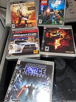 Photo of five PlayStation 3 game cases laid out together showing the front covers.