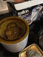 Vintage Salton ultrasonic jewelry cleaner with amber plastic lid and original box