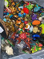Assorted Skylanders figures shown in a container, various character designs and colors visible