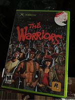 Front view of The Warriors Xbox game case showing cover art and details