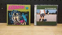 Front covers of two Alexisonfire CDs, 'Watch Out!' and self-titled album.