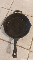 Top view of cast iron skillet pan showing the interior cooking surface and handle.