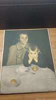Front view of the oil painting on canvas showing two children and the artist's signature in bottom right corner.