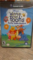 Front cover of the Nintendo GameCube game 'Winnie the Pooh's Rumbly Tumbly Adventure' showing the game title and characters on a colorful background.