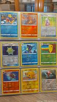 Photo showing 9 Pokemon cards including Gyarados, Charmander, Hyper Potion, Metal Core Barrier, Starmie, Weepinbell, Pidgeotto, Pikachu, and Porygon.