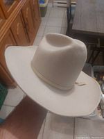 Front and side view of white felt Big Country 3000 Ranch hat showing shape, wide brim and crown crease.