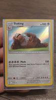 Front of the Slaking Holo Pokémon card showing artwork and details.