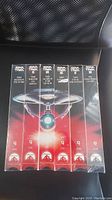 Front view of the sealed Star Trek VHS tapes showing titles The Wrath of Khan to The Undiscovered Country.