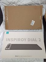 Two sealed boxes of Huion Inspiroy Dial 2 pen tablets in white packaging with the product image on the front.