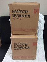 Two sealed cardboard boxes labeled Triple Tree Watch Winder GJ-14001 US stacked.