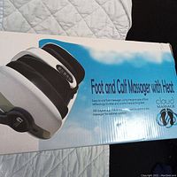 Photo of the Cloud Massage foot and calf massager box showing the product image and branding, detailing features such as heat and adjustable positioning.