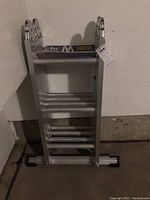 Folded view of the aluminum ladder showing rungs and stabilizer feet