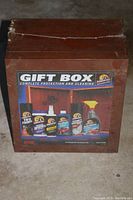 Front view of the wooden gift box with label showing the contents - six Armor All branded car cleaning products.