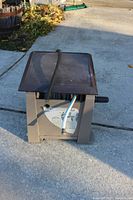 Front view of the hose reel with brown lid and hoses attached