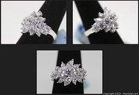 Three angled photos of the sterling silver flower ring with marquise simulant diamonds on a black ring holder showing detailed views of the flower design.