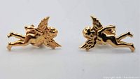 Front view of both cherub earrings on white background