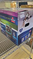 Box of Bissell Little Green Pet Pro showing branding, product image, and pet-themed packaging.