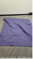 Photo of one purple moving blanket laid out on floor showing size and condition.
