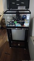 Front view of the fish tank on the stand showing decals on tank sides and aquarium accessories inside.