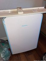 Full view of white Keystone portable air conditioner showing front panel and unit on wheels.