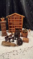 Full display of all wooden collectable items on lace tablecloth against black patterned background