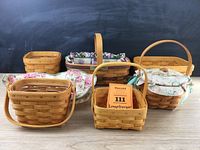 Photo showing all six Longaberger baskets arranged on wooden surface, four with handles and three with liners