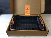 Longaberger serving tray basket inside the original box showing the basket with fabric liner and ruffled edges.