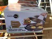 Photo of the GreenPan non-stick grill enameled cast iron pan box showing front with product image and highlights like healthy, eco-friendly, easy.