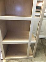 Photo showing the unfinished plywood frame with square compartments.