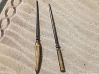 Overview showing both antique steels on fabric background highlighting blade length and handle details