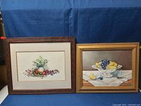 Front view of the two framed paintings side by side showing subject matter and frames.