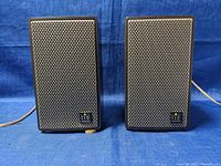 Front view of both Grundig Hi-Fi speakers showing metal mesh grills and hi-fi logos.