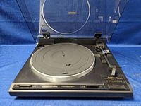 Full view of Pioneer turntable with dust cover open showing platter, controls, and tonearm.