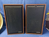 Front view of the pair of Telefunken speakers with grills attached, showing wood veneer frames and black fabric covers.