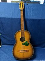 Full front view of the vintage Suzuki acoustic guitar showing body, neck, headstock, and strings.