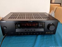 Front view of Yamaha AV Receiver showing its display and controls.
