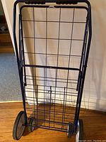 Blue metal folding bundle buggy with two wheels and wire frame