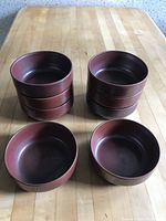 Set of 8 reddish-brown matte finish ceramic bowls arranged in two stacks of four and two bowls in front, showing size and quantity