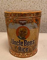 Photo of Uncle Ben's Rice collector tin with detailed orange and gold design featuring Uncle Ben's portrait