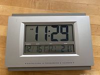 Front view of large digital clock showing time 11:29 AM, date 12/16 Fri, and temperature 21.5 degrees.