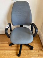 Grey office chair with cushioned seat, backrest, and armrests on caster wheels