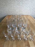 Top view showing 28 glasses arranged by type on table, including stemmed and stemless glasses.